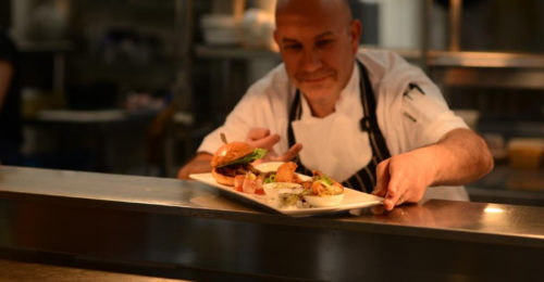 chef presenting plate of food